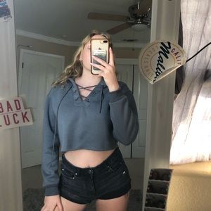 Blue long sleeve top with hood and cross design